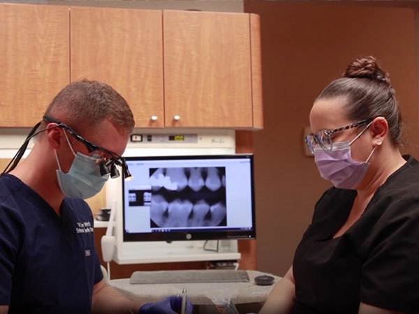 Dentists working together to treat dental patient