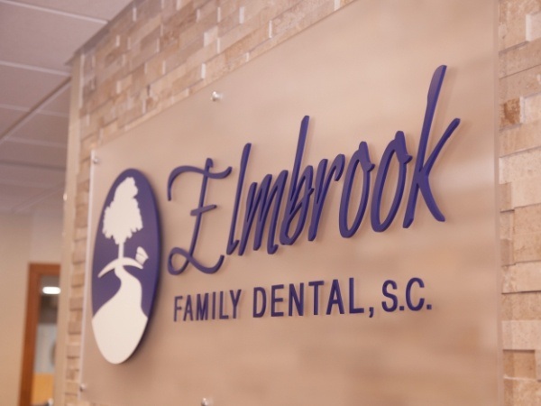 Elmbrook Family Dental logo on a wall