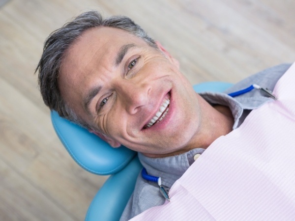 Man smiling during biannual dental checkup