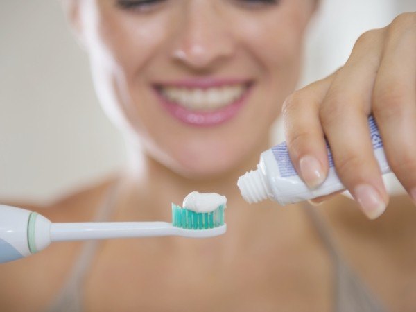 Person brushing teeth to prevent dental emergencies