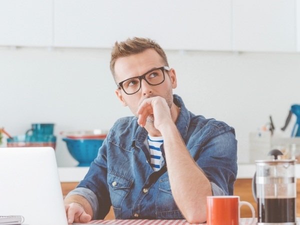 Man considering emergency dentistry frequently asked questions