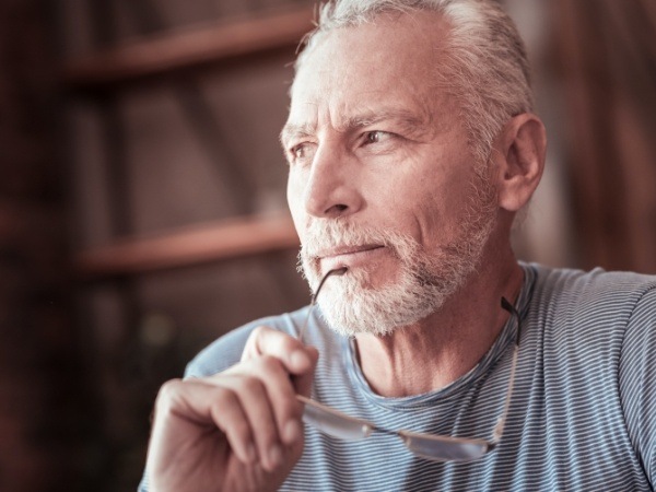 Man considering implant dentures