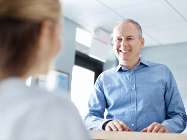 Man discussing the cost of dental implants