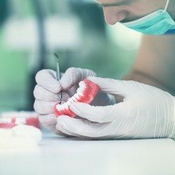 Person crafting a denture