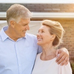 Man and woman discussing dental implant costs