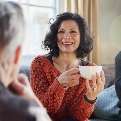 Smiling woman holding a cup of coffee