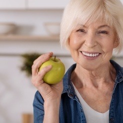 Smiling woman holding an apple