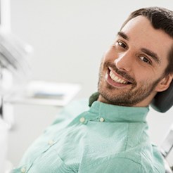 Male patient smiling while relaxing in treatment chair