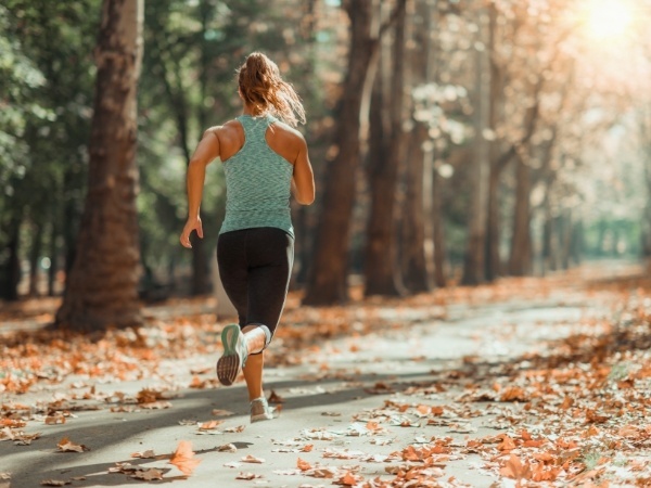 Woman running down a trail