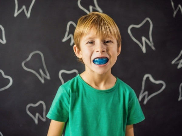 Child with myofunctional therapy appliance