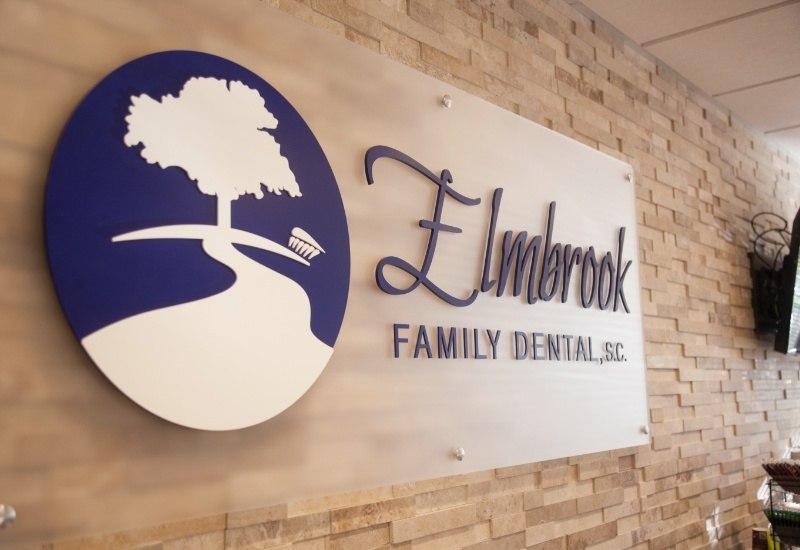 Elmbrook Family Dental logo on dental office wall