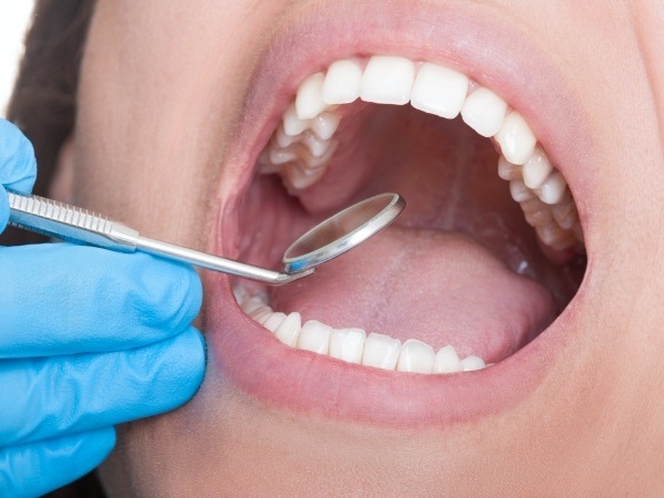 Dental patient receiving an oral cancer screening