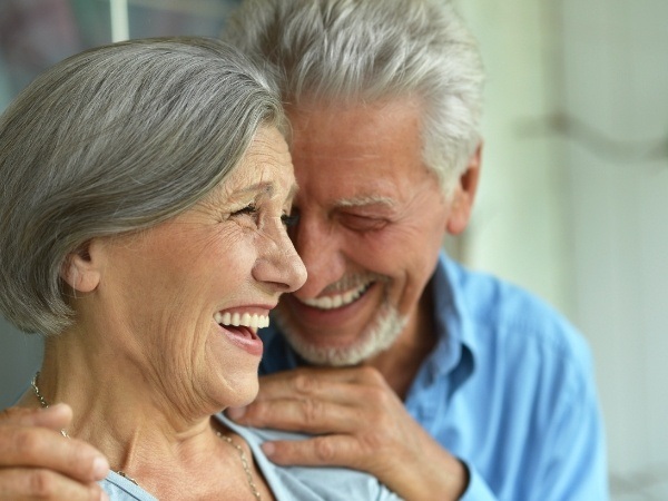 Woman smiling after full mouth reconstruction