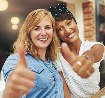 Two women with flawless smiles thanks to cosmetic dentistry