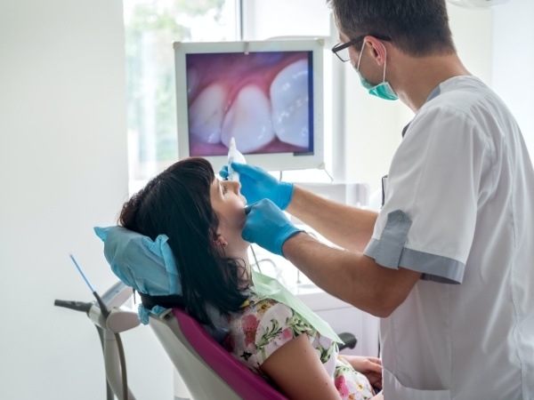 Dentist capturing smile images with intraoral camera