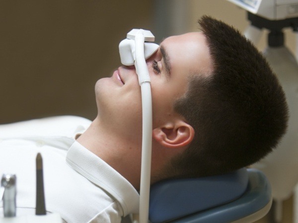 Dental patient receiving nitrous oxide sedation dentistry treatment