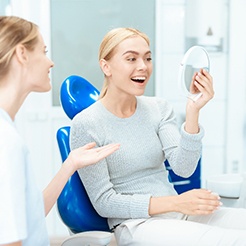 A woman meeting with her cosmetic dentist