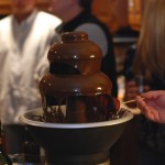 Person holding a plate of chocolate fondue