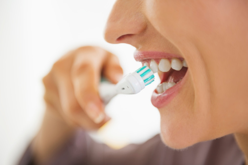 woman brushing her teeth