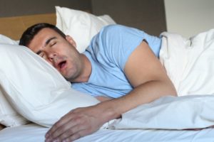 man asleep drooling on pillow