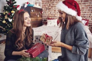 woman smiling wearing red santa hat