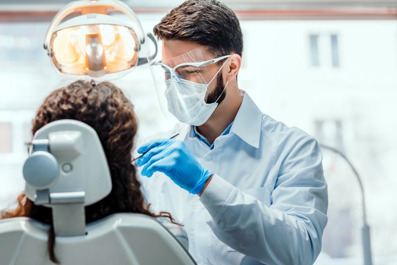 Dentist wearing PPE during dental exam