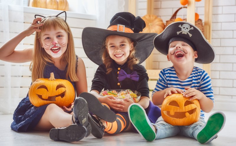 children in Halloween costumes with candy