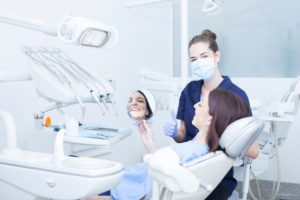 dental hygienist cleaning patient’s mouth 