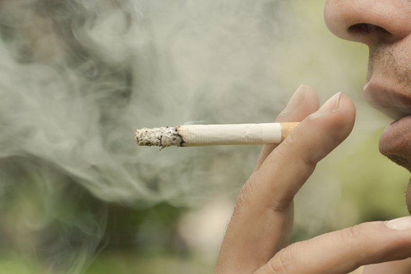 closeup of a man smoking a cigarette