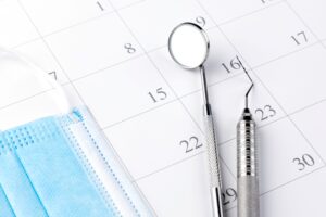 Dental instruments and mask sitting on a calendar page