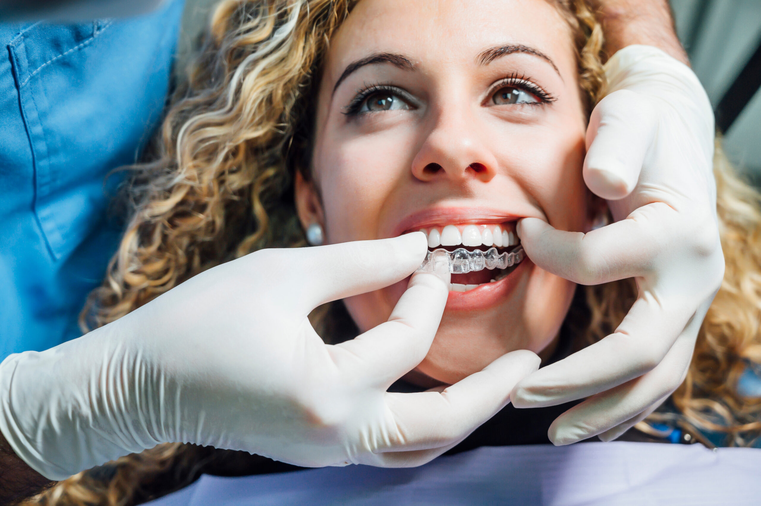 Dentist giving patient her Invisalign aligner